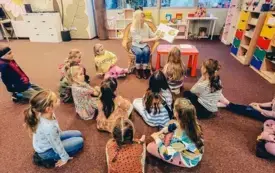 Bibliotekarka czyta dzieciom książkę pt.: &bdquo;Bądź przy mnie zawsze&rdquo; Anny Paszkiewicz. 