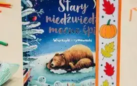 Na sztaludze jesienna zakładka i książka &bdquo;Stary niedźwiedź mocno śpi&rdquo;.