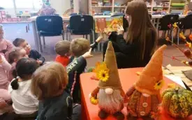 Bibliotekarka czyta dzieciom książkę. 