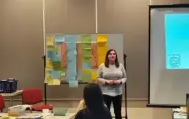 Trenerka szkolenia omawia z uczestnikami szkolenia kolejność procesu ubytkowania zbior&oacute;w bibliotecznych.