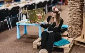 Pani Bibliotekarka czyta dzieciom książkę.