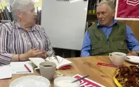 Kobieta i mężczyzna siedza przy stole i dyskutują