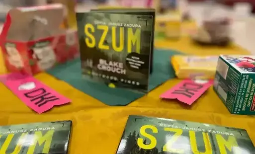 Na stole przykrytym obrusem leżą audiobooki oraz zakładki DKK