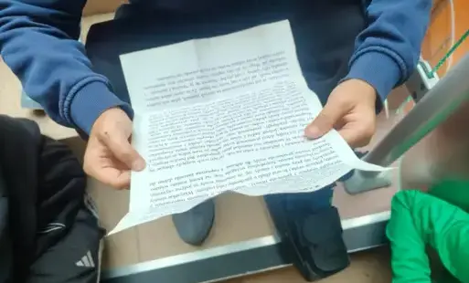 Uczeń trzyma w ręce tekst legendy o studni czarownic