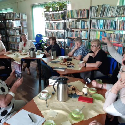 Wnętrze biblioteki. Przy stołach członkowie Klubu dyskutują o książce. Kliknięcie powoduje powiększenie zdjęcia.